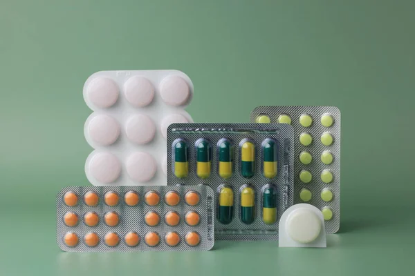 Different Pills Green Background Healthcare Concept Copy Space — стоковое фото
