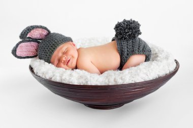 Newborn baby boy wearing bunny ears and a bunny tail