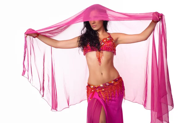 Exotic belly dancer wearing a hot pink costume and draped in a hot pink veil. — Stock Photo, Image