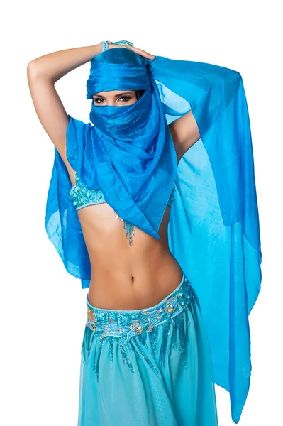 Exotic belly dancer peeking from behind a blue veil wrapped — Stock Photo, Image