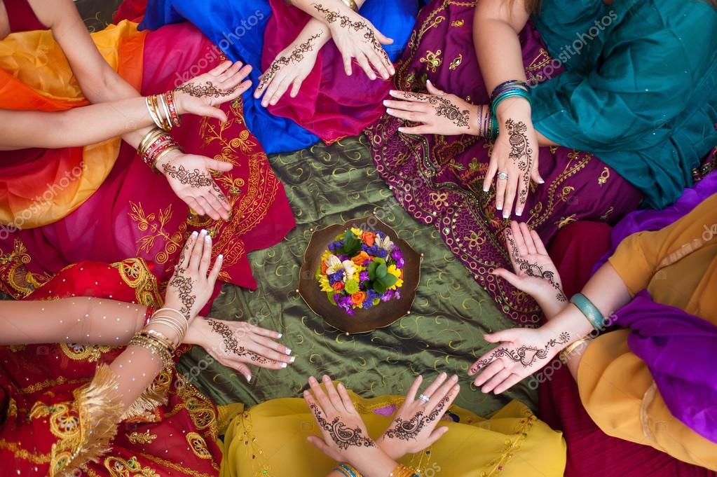 Six pairs of henna decorated female hands arranged in a circle on a  colorful background. Stock Photo by ©katrinaelena 25582783