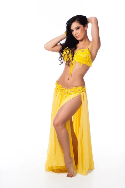 Full length photo of a beautiful belly dancer wearing a bright yellow costume. — Stock Photo, Image