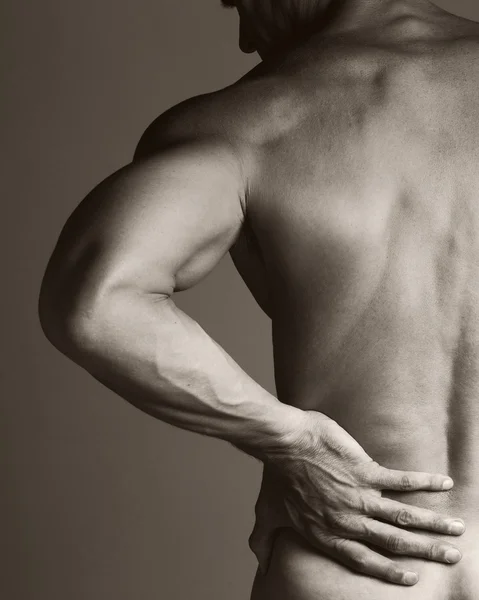 Hombre muscular con dolor de espalda — Foto de Stock