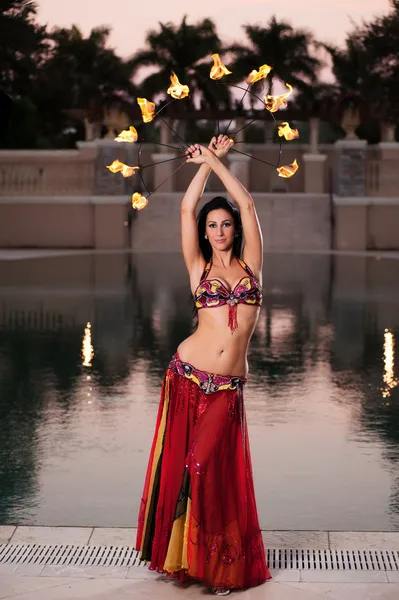 Belly Dancer in Red Costume with Fire Fans