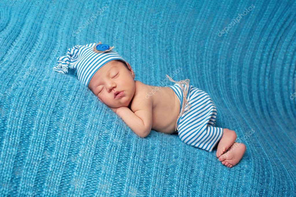 Sleeping Newborn Baby Wearing Striped Pajamas Stock Photo by