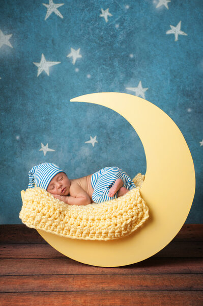 Newborn Boy Sleeping on the Moon