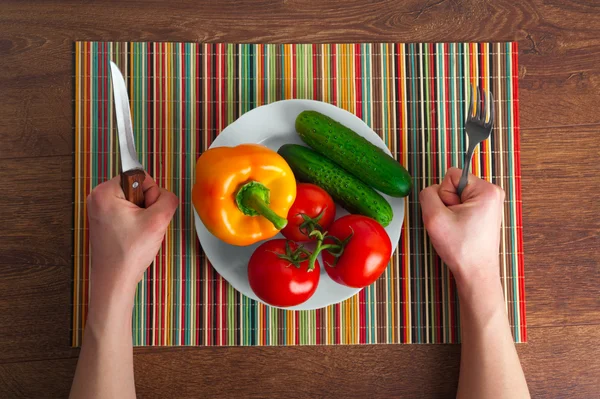 Hands on the table with vegetables — Stock Photo, Image