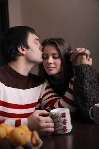 Man gently kisses the girl at breakfast — Stock Photo, Image