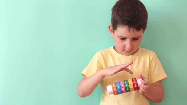 Caucasian Preschool Boy Arithmetic Math Learning Toy Light Green Background — Vídeo de Stock