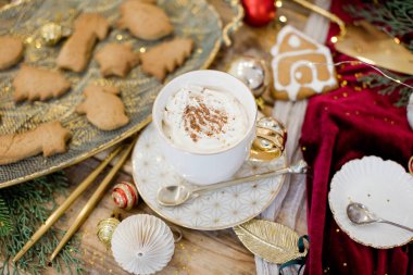 Hot cocoa drink on a wooden vintage table with Christmas decorations