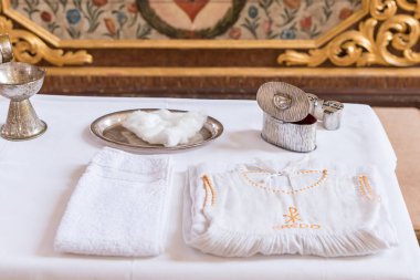 chrisam oil in a vessel and holy water in a bowl. Preparation for the sacrament baptism 