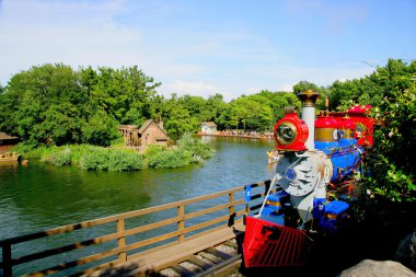 Tokyo Disneyland park along the river in the western train clipart