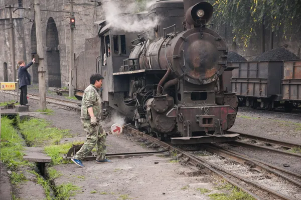 楽山市、四川チエンウェイ歌謡飛躍駅道されている輸送列車を手動で移動する労働者 — ストック写真