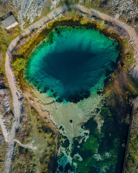 Landmark croatia: famous pond, blue hole Izvor Cetine, Dalmatia.