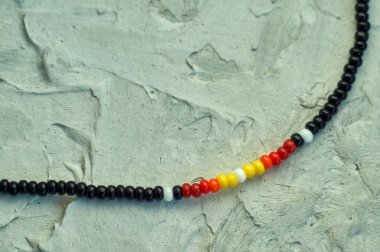 El yapımı boncuk, hobi olarak boncuklama. Çeşitli çiçek ve bitkilerin arka planında kendi ellerinizle yapılmış süslemeler..