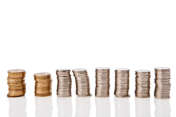 Coins stacked on white background with a reflection — Stock Photo, Image