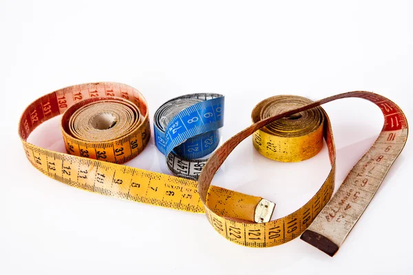 Old yellow red blue measure tapes rolled — Stock Photo, Image