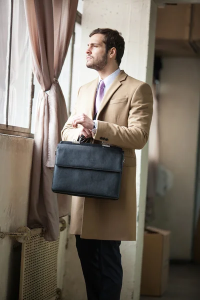 Young and handsome businessman looking out of the window — Stock Photo, Image