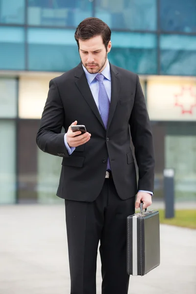 Businessman looking at his phone — Stock Photo, Image