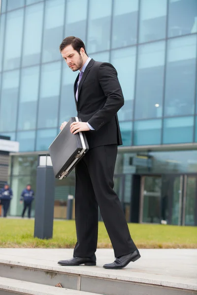 Businessman holding his briefcase Stock Picture
