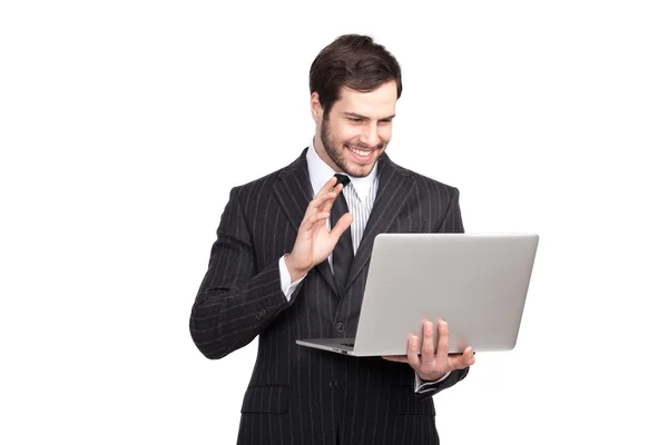 Wahandsome biznesmen z laptopa w ręku macha szary — Zdjęcie stockowe