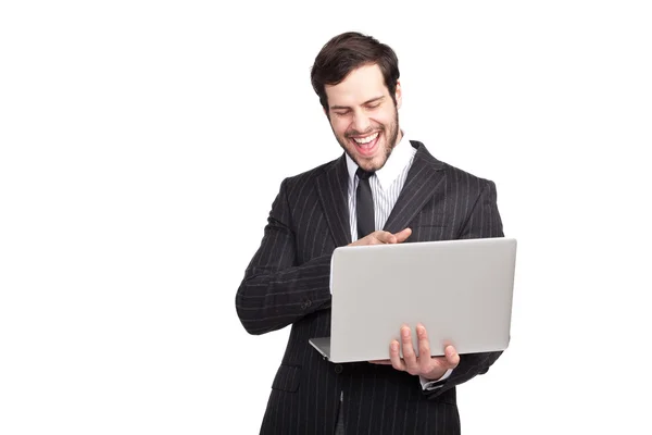 Hombre de negocios sonriendo a su portátil —  Fotos de Stock