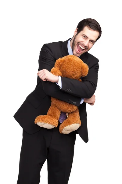 Geschäftsmann umarmt einen Teddy — Stockfoto