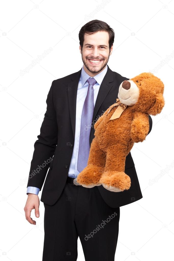 Smiling businessman with teddy bear