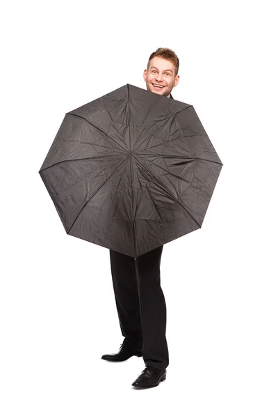 Uomo d'affari sorridente con ombrello — Foto Stock