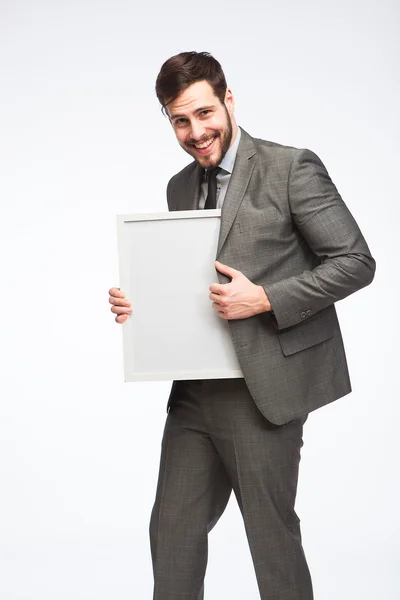 Smiling man with framed board — Stock Photo, Image