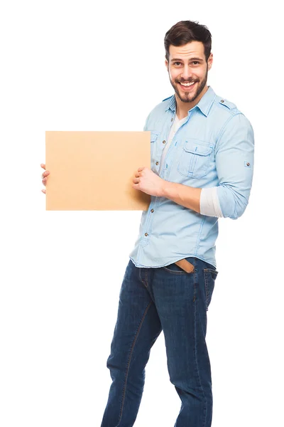 Joven hombre guapo casual vestido con panel de madera en blanco — Foto de Stock