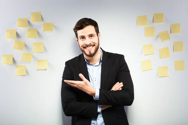 Man standing next to a wall with postits — Stock Photo, Image
