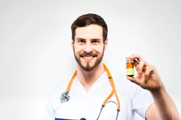 Handsome doctor showing pills — Stock Photo, Image