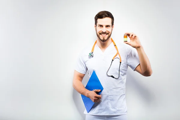 Handsome doctor showing pills — Stock Photo, Image
