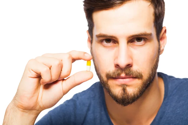 Handsome man showing pills — Stock Photo, Image