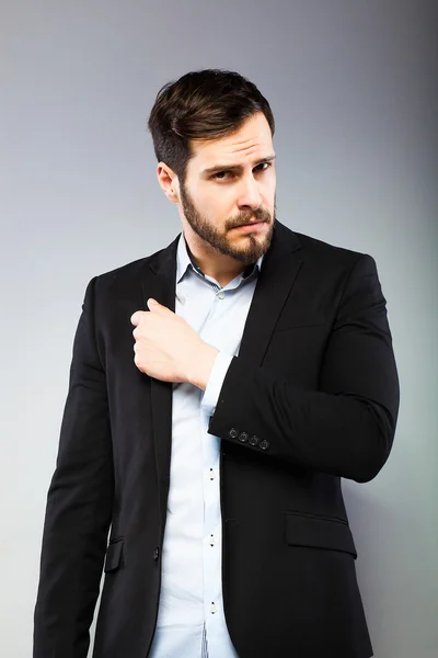 Portrait of a smart serious young man standing — Stock Photo, Image