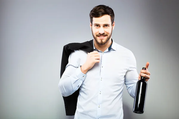 Handsome man opening bottle of wine — Stock Photo, Image