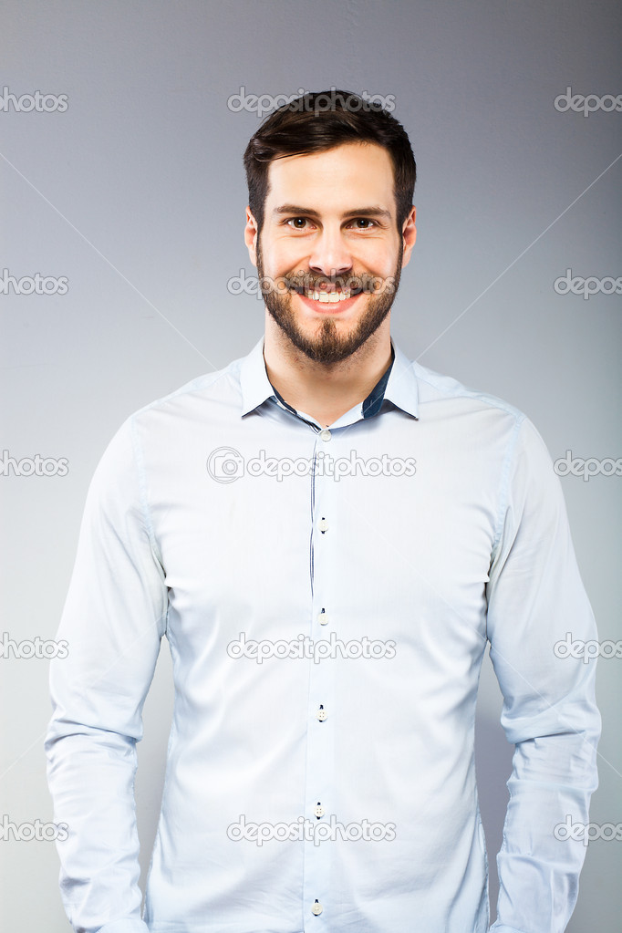 Portrait of a smart serious young man standing 