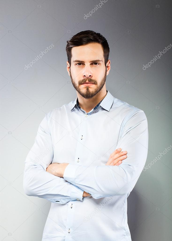 Portrait of a smart serious young man standing 