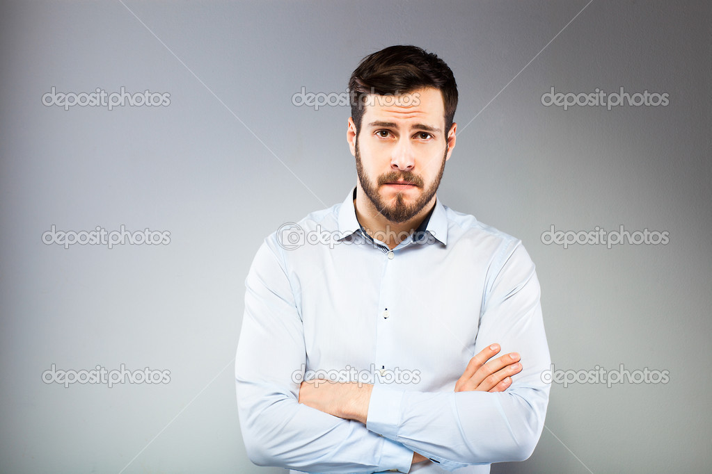 Portrait of a smart serious young man standing 