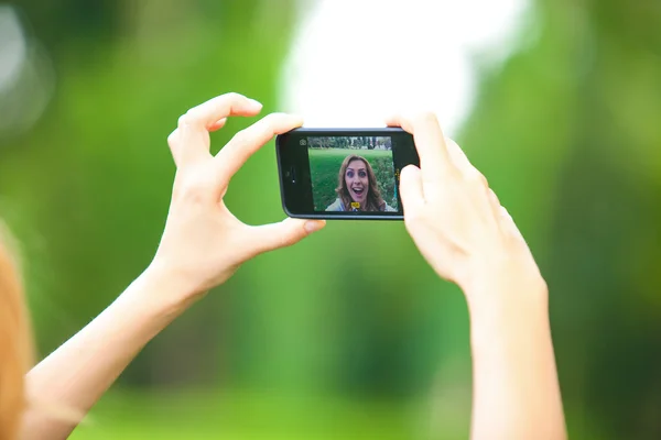Nice woman taking pictures with smartphone — Stock Photo, Image