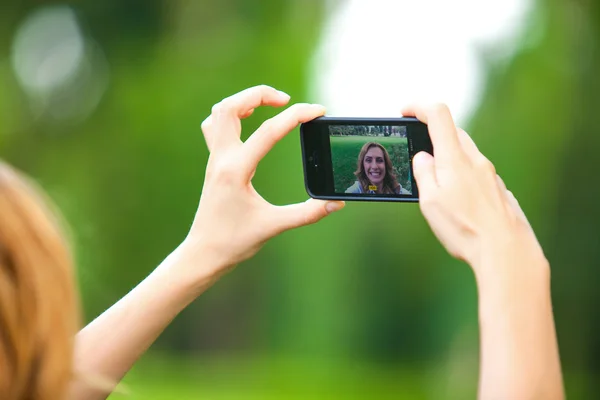 Nice woman taking pictures with smartphone — Stock Photo, Image