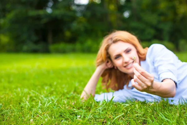 Beautiful young woman relaxing in grass Stock Picture