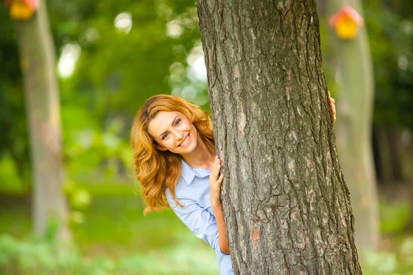 Beautiful woman playing in park — Stock Photo, Image
