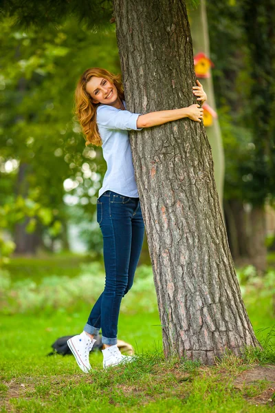 Beautiful woman playing in park — Stock Photo, Image