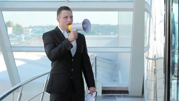 Young city businessman announcing his achievements with a megaphone — Stock Video