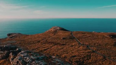 Monument to King Arthur in Britain Aerial view of a rock on a background of the sea 