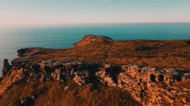 Monument to King Arthur in Britain Aerial view of a rock on a background of the sea 