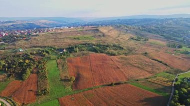 Ukrainian fields stretch on the hills near the settlements Aerial view 