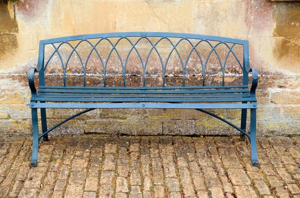 Iron bench against Bath stone building — Stock Photo, Image